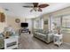 Comfortable living room with a ceiling fan, floral print furniture, and electric fireplace at 9743 36Th N Way # 4, Pinellas Park, FL 33782