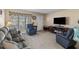 Inviting living room featuring a cozy fireplace, comfortable seating, and large windows for natural light at 9743 36Th N Way # 4, Pinellas Park, FL 33782