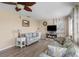 Cozy living room with floral print furniture, fireplace, and neutral walls at 9743 36Th N Way # 4, Pinellas Park, FL 33782