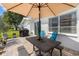 Outdoor patio featuring a picnic table with umbrella and pavers at 9743 36Th N Way # 4, Pinellas Park, FL 33782