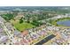 Expansive aerial view of community with ponds and green spaces nestled among single-Gathering homes on tree-lined streets at 10626 Laguna Plains Dr, Riverview, FL 33578