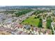 Aerial view showcases a community surrounded by lush greenery, featuring well-maintained homes and scenic ponds at 10626 Laguna Plains Dr, Riverview, FL 33578