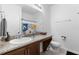 Bathroom featuring a vanity with granite countertops, a decorative mirror, and a shower-tub combo at 10626 Laguna Plains Dr, Riverview, FL 33578