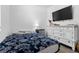 Comfortable bedroom featuring a large dresser with a modern television set for entertainment at 10626 Laguna Plains Dr, Riverview, FL 33578