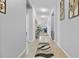 Long hallway showcasing tiled floors and decor leading to open-concept spaces at 10626 Laguna Plains Dr, Riverview, FL 33578