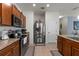 The kitchen is equipped with stainless steel appliances, granite countertops, and custom cabinets at 10626 Laguna Plains Dr, Riverview, FL 33578