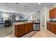 Open kitchen features a large island, stainless steel appliances, granite counters and views to the dining and living areas at 10626 Laguna Plains Dr, Riverview, FL 33578