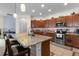 Spacious kitchen with a large island, stainless steel appliances, and wooden cabinetry at 10626 Laguna Plains Dr, Riverview, FL 33578