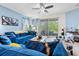 Comfortable living room with stylish decor, large windows and a ceiling fan at 10626 Laguna Plains Dr, Riverview, FL 33578
