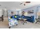 Open-concept living area featuring stylish blue sofas and connecting dining area at 10626 Laguna Plains Dr, Riverview, FL 33578