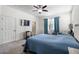 The main bedroom boasts a ceiling fan, and a view to the window with sheer curtains at 10626 Laguna Plains Dr, Riverview, FL 33578