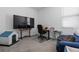 Office space featuring a wooden desk, executive chair, and a large screen TV for a productive workspace at 10626 Laguna Plains Dr, Riverview, FL 33578