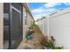 Outdoor space featuring an exterior wall, screen door, and a narrow space for gardening or storage at 10626 Laguna Plains Dr, Riverview, FL 33578