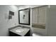 Bathroom features granite countertops, updated fixtures, and wall-mounted TV at 11201 122Nd Ave # 103, Largo, FL 33778