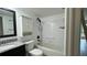 Bathroom featuring updated vanity and bath tub with white tile and updated fixtures at 11201 122Nd Ave # 103, Largo, FL 33778