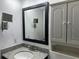 Bathroom features granite countertops, updated fixtures, and wall-mounted TV at 11201 122Nd Ave # 103, Largo, FL 33778