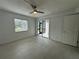 Bright bedroom with tile flooring, ceiling fan, and sliding door access to the screened in porch at 11201 122Nd Ave # 103, Largo, FL 33778