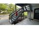 Staircase leading to the condo entrance complemented by a lush green landscape at 11201 122Nd Ave # 103, Largo, FL 33778