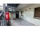 Exterior concrete patio area with view of stairs and a red fire extinguisher box on the wall at 11201 122Nd Ave # 103, Largo, FL 33778