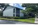 This angle of the condo shows well-maintained landscaping, healthy lawn, and a screened balcony at 11201 122Nd Ave # 103, Largo, FL 33778