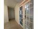 Hallway leading to rooms with decorative glass doors and tile floors at 11201 122Nd Ave # 103, Largo, FL 33778