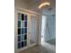 Hallway with decorative glass doors offers entry to rooms and bath at 11201 122Nd Ave # 103, Largo, FL 33778