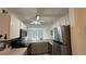 Modern kitchen with stainless steel appliances, white cabinetry, and view to screened in porch at 11201 122Nd Ave # 103, Largo, FL 33778