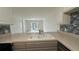 Bright kitchen featuring stone countertops, tile backsplash, and view to adjacent room and screened in porch at 11201 122Nd Ave # 103, Largo, FL 33778