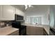 Kitchen featuring stainless steel appliances, white cabinets, and a view to the living room at 11201 122Nd Ave # 103, Largo, FL 33778