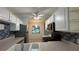 Well-lit kitchen with stainless steel appliances, tile backsplash, and white cabinets at 11201 122Nd Ave # 103, Largo, FL 33778