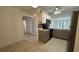 Spacious kitchen featuring stainless steel appliances, white cabinets, and tile flooring at 11201 122Nd Ave # 103, Largo, FL 33778