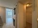 Laundry area featuring stacked washer and dryer, with access to the hall and walk-in closet at 11201 122Nd Ave # 103, Largo, FL 33778