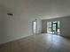 Sunlit living room with tile flooring and sliding glass doors to the screened porch at 11201 122Nd Ave # 103, Largo, FL 33778