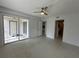 Open floor plan with sliding glass doors to the porch and a ceiling fan at 11201 122Nd Ave # 103, Largo, FL 33778