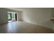 Spacious living room with tile flooring and sliding door access to the lanai at 11201 122Nd Ave # 103, Largo, FL 33778