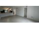 Bright living room with tile flooring and an open layout leading to the kitchen at 11201 122Nd Ave # 103, Largo, FL 33778