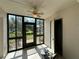 Enclosed patio with ceiling fan and views of the lawn and trees at 11201 122Nd Ave # 103, Largo, FL 33778