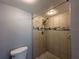 Tiled walk-in shower featuring a shower head and decorative mosaic tile accent at 11201 122Nd Ave # 103, Largo, FL 33778