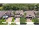 An aerial view of a two-story home featuring a brick driveway, well-manicured lawn, and mature landscaping at 11205 Lark Landing Ct, Riverview, FL 33569