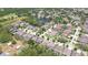 An aerial view of a residential neighborhood featuring well-maintained homes, landscaping, and a pond at 11205 Lark Landing Ct, Riverview, FL 33569