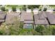 Aerial view of a home with a screened-in pool and patio area, surrounded by lush landscaping at 11205 Lark Landing Ct, Riverview, FL 33569