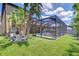 Lush backyard showcasing a screened-in pool and patio area, creating a private oasis with beautiful landscaping at 11205 Lark Landing Ct, Riverview, FL 33569