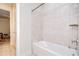 Bright bathroom featuring a tub with shower and access to adjacent rooms at 11205 Lark Landing Ct, Riverview, FL 33569