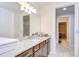 Neutral toned bathroom features a granite countertop, under-mount sink, and views of adjacent rooms at 11205 Lark Landing Ct, Riverview, FL 33569