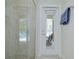 Bathroom offers a shower and doorway leading to an outdoor patio area with seating at 11205 Lark Landing Ct, Riverview, FL 33569