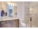 Well-lit bathroom features a granite countertop, undermount sink, toilet, and glass shower with tile surround at 11205 Lark Landing Ct, Riverview, FL 33569