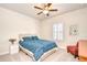 Bedroom with ceiling fan, white shutters, and blue bedding; neutral walls and carpet at 11205 Lark Landing Ct, Riverview, FL 33569