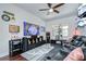 Home entertainment room with Star Wars themed decor, large TV, ceiling fan, and plush leather seating at 11205 Lark Landing Ct, Riverview, FL 33569