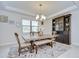 Elegant dining room with chandelier lighting, light-toned table, and decorative hutch at 11205 Lark Landing Ct, Riverview, FL 33569