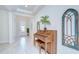 Welcoming entryway with neutral tile, a vintage piano and an arched wall decoration at 11205 Lark Landing Ct, Riverview, FL 33569